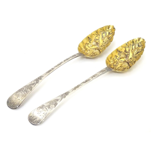 366 - A pair of white metal serving spoons with Aesthetic Movement birds amongst foliage decoration and ha... 