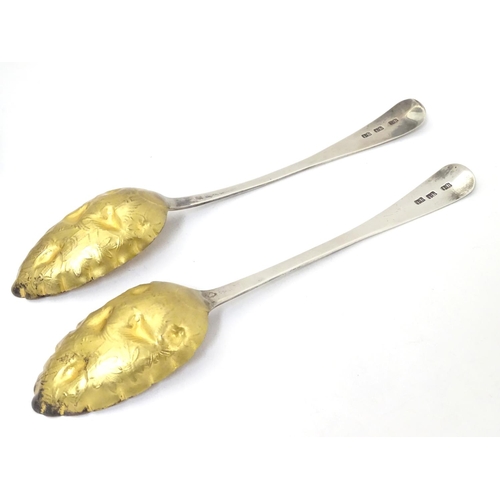 366 - A pair of white metal serving spoons with Aesthetic Movement birds amongst foliage decoration and ha... 