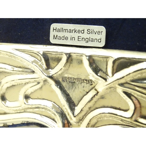 369 - A photograph frame with silver surround having Art Nouveau style decoration. Hallmarked London 2020.... 