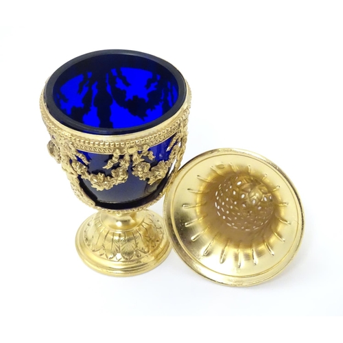 381 - A silver gilt caster with swag detail and blue glass liner. Marked with importers mark for John Geor... 