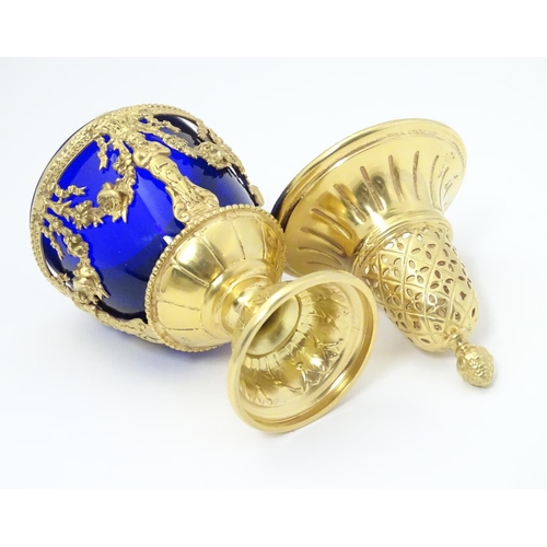 381 - A silver gilt caster with swag detail and blue glass liner. Marked with importers mark for John Geor... 