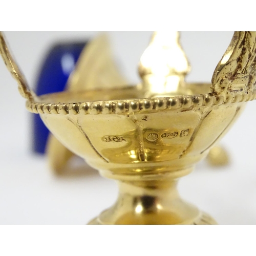 381 - A silver gilt caster with swag detail and blue glass liner. Marked with importers mark for John Geor... 