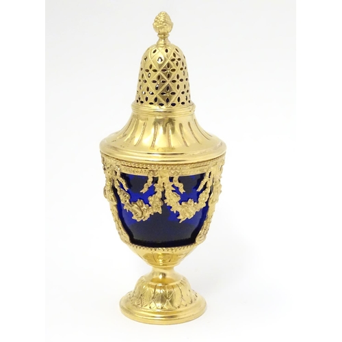 381 - A silver gilt caster with swag detail and blue glass liner. Marked with importers mark for John Geor... 