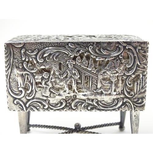 385 - A Continental silver novelty  pomander box formed as a drop flap table with figural and acanths deco... 