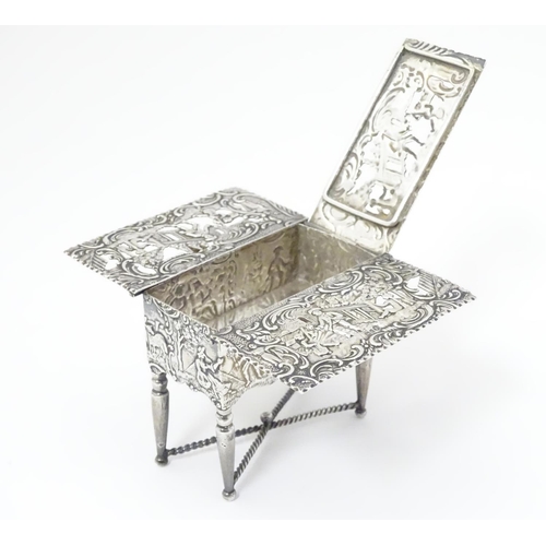 385 - A Continental silver novelty  pomander box formed as a drop flap table with figural and acanths deco... 