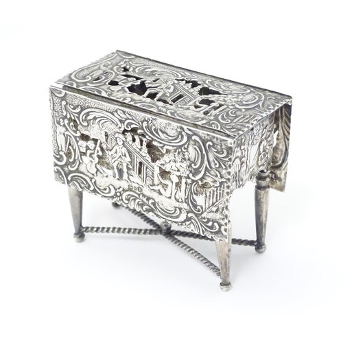 385 - A Continental silver novelty  pomander box formed as a drop flap table with figural and acanths deco... 