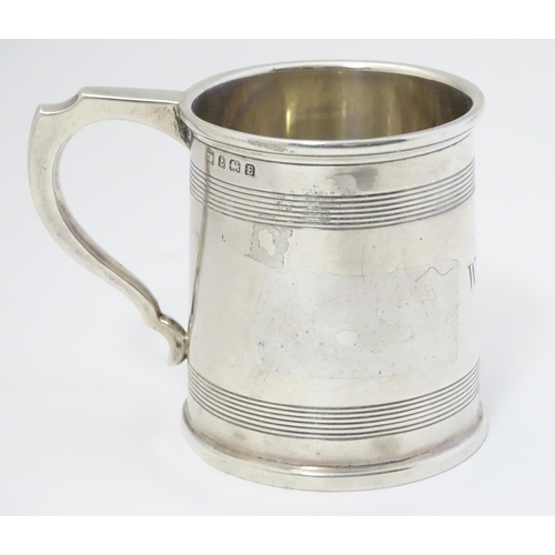 403 - An Art Deco silver tankard with banded decoration. Hallmarked Birmingham 1929 maker A & J Zimmerman ... 