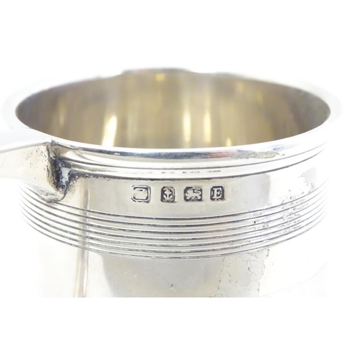 403 - An Art Deco silver tankard with banded decoration. Hallmarked Birmingham 1929 maker A & J Zimmerman ... 