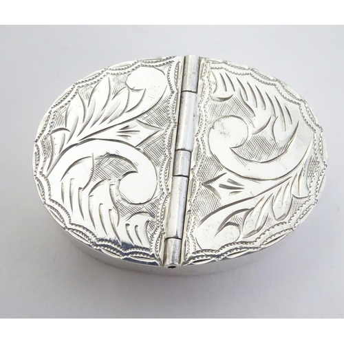 406 - A silver two sectional pill box with engraved decoration to the hinged lids. 1 3/4