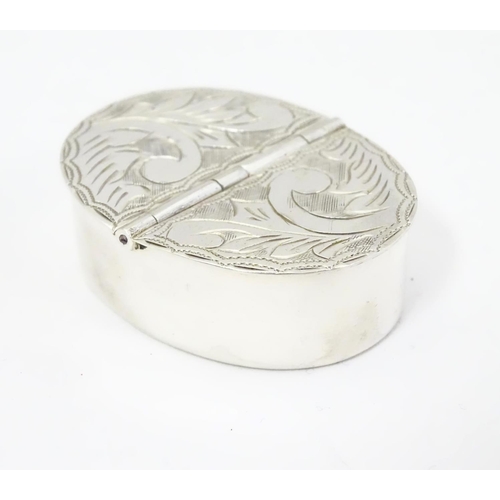 406 - A silver two sectional pill box with engraved decoration to the hinged lids. 1 3/4