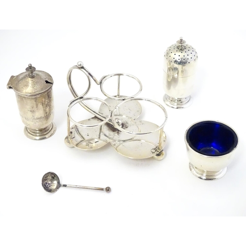 410 - A Victorian silver three piece cruet set on stand, the stand raised on three ball feet and with loop... 