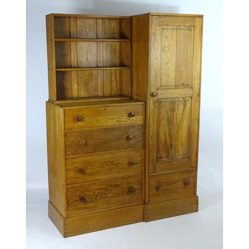 1369 - An early / mid 20thC oak combination wardrobe to a design by Peter Waals, Loughborough University. T... 