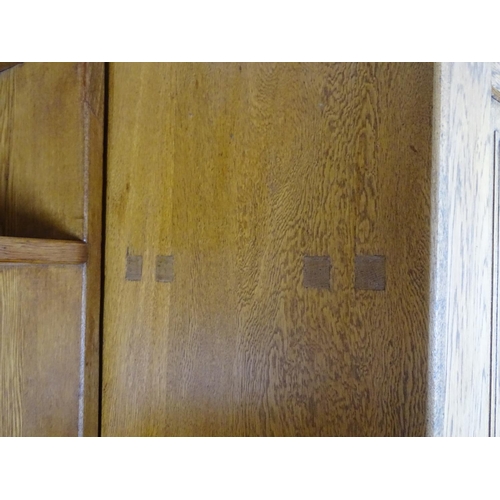 1369 - An early / mid 20thC oak combination wardrobe to a design by Peter Waals, Loughborough University. T... 