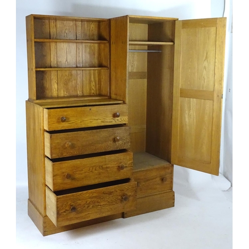 1369 - An early / mid 20thC oak combination wardrobe to a design by Peter Waals, Loughborough University. T... 