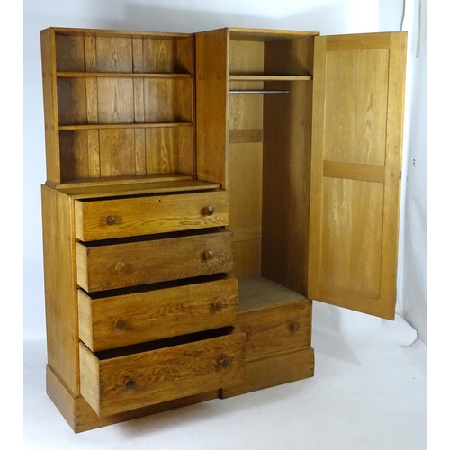 1369 - An early / mid 20thC oak combination wardrobe to a design by Peter Waals, Loughborough University. T... 