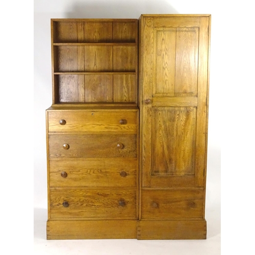 1369 - An early / mid 20thC oak combination wardrobe to a design by Peter Waals, Loughborough University. T... 