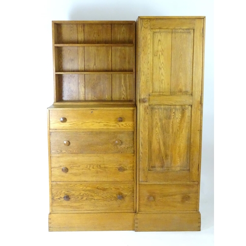 1369 - An early / mid 20thC oak combination wardrobe to a design by Peter Waals, Loughborough University. T... 