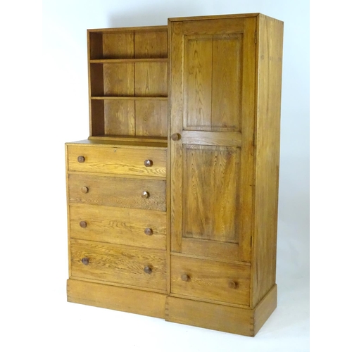 1369 - An early / mid 20thC oak combination wardrobe to a design by Peter Waals, Loughborough University. T... 