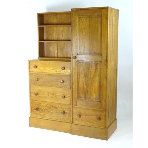 1369 - An early / mid 20thC oak combination wardrobe to a design by Peter Waals, Loughborough University. T... 