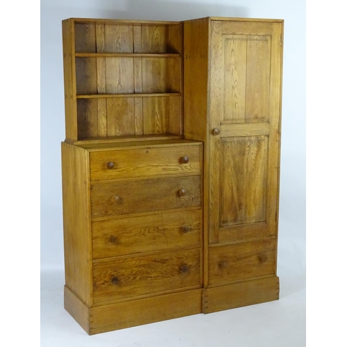 1369 - An early / mid 20thC oak combination wardrobe to a design by Peter Waals, Loughborough University. T... 