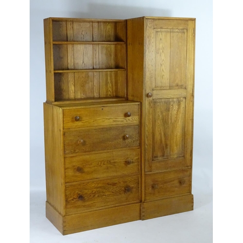 1369 - An early / mid 20thC oak combination wardrobe to a design by Peter Waals, Loughborough University. T... 