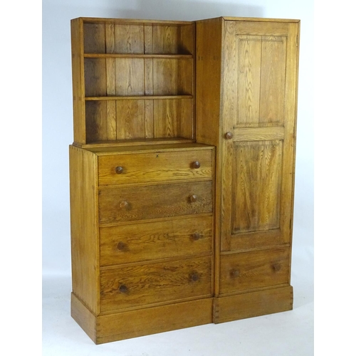 1369 - An early / mid 20thC oak combination wardrobe to a design by Peter Waals, Loughborough University. T... 