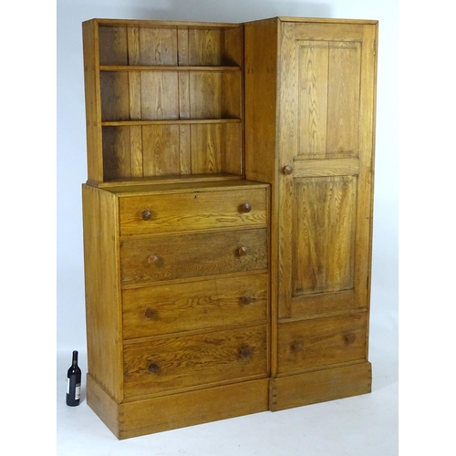 1369 - An early / mid 20thC oak combination wardrobe to a design by Peter Waals, Loughborough University. T... 