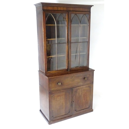 1378 - A Regency secretaire bookcase with a moulded cornice above two glazed doors with astragal glazed mou... 