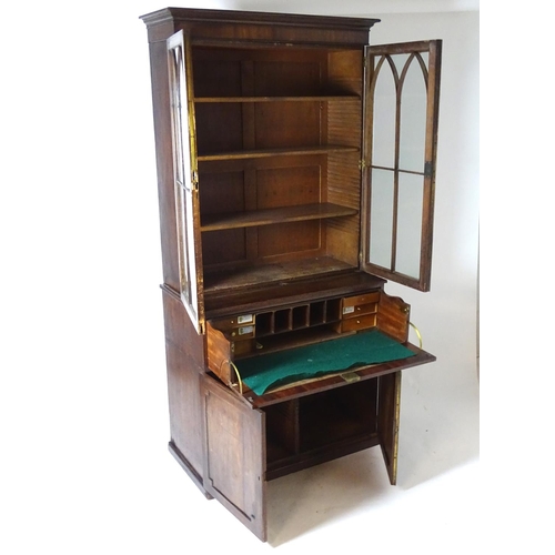 1378 - A Regency secretaire bookcase with a moulded cornice above two glazed doors with astragal glazed mou... 