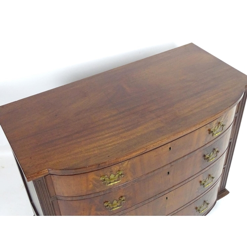 1379 - A mid / late 19thC mahogany bow fronted chest of drawers, comprising four long drawers with figured ... 