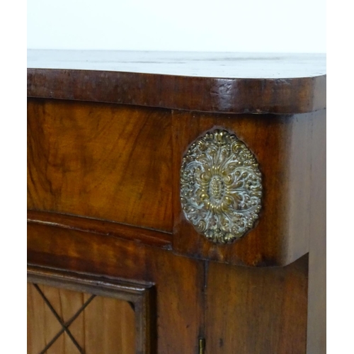 1393 - A mid / late 19thC mahogany chiffonier, with brass mounts flanking a single long drawer above two do... 