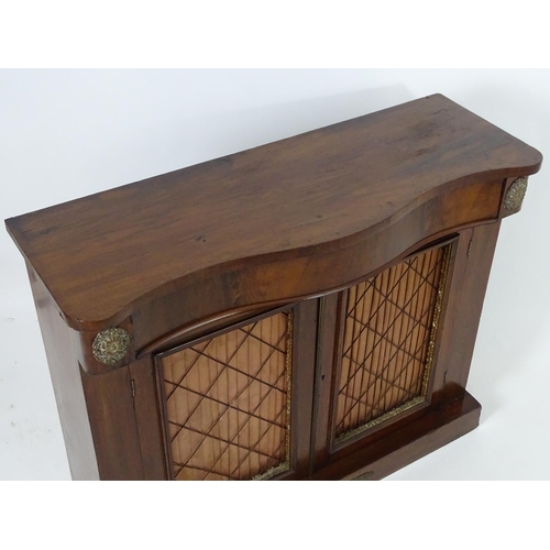 1393 - A mid / late 19thC mahogany chiffonier, with brass mounts flanking a single long drawer above two do... 