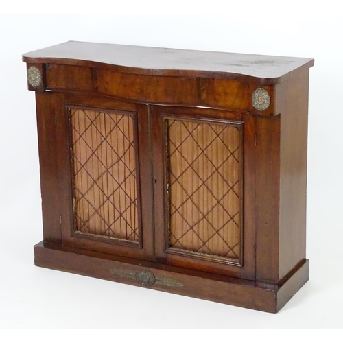 1393 - A mid / late 19thC mahogany chiffonier, with brass mounts flanking a single long drawer above two do... 