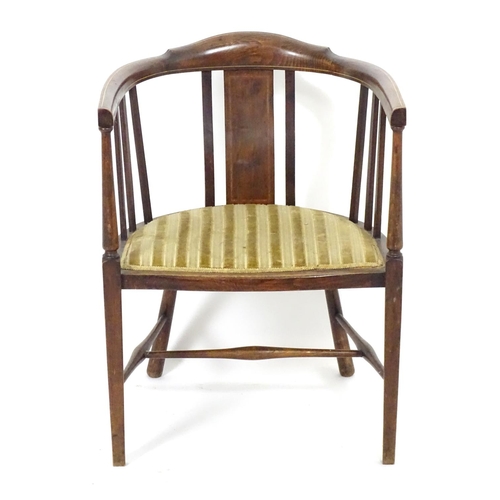 1554 - An early 20thC bow back open armchair with slatted supports above an upholstered seat and standing o... 