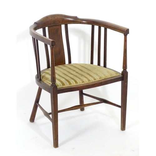 1554 - An early 20thC bow back open armchair with slatted supports above an upholstered seat and standing o... 