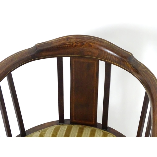 1554 - An early 20thC bow back open armchair with slatted supports above an upholstered seat and standing o... 