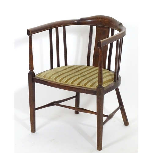 1554 - An early 20thC bow back open armchair with slatted supports above an upholstered seat and standing o... 