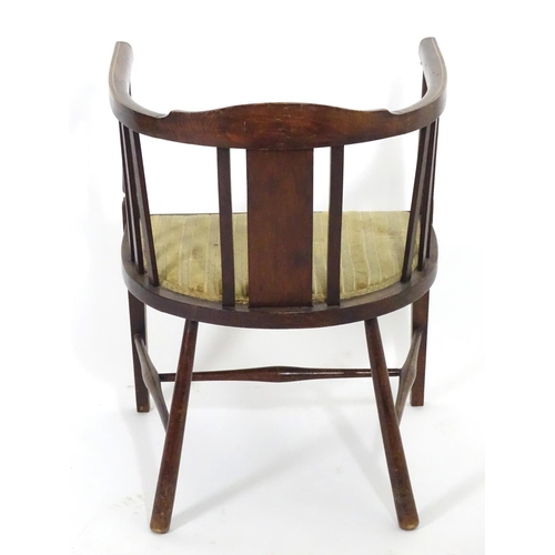 1554 - An early 20thC bow back open armchair with slatted supports above an upholstered seat and standing o... 