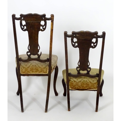 1555 - Two early 20thC side chairs with shaped top rails above tapered and pierced back splats with marquet... 