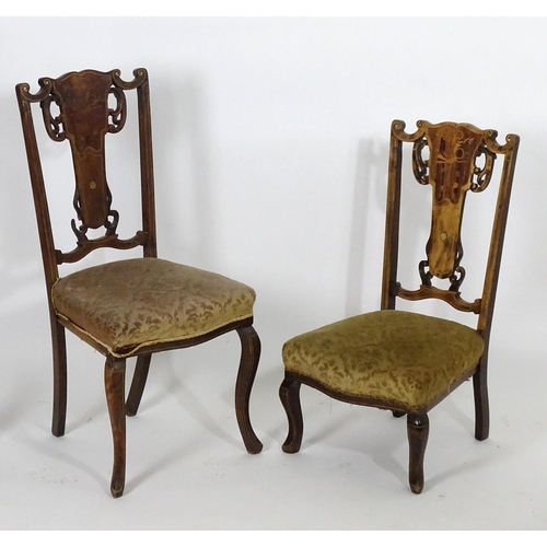 1555 - Two early 20thC side chairs with shaped top rails above tapered and pierced back splats with marquet... 