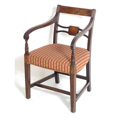 1558 - A Regency mahogany carver chair with a flame mahogany top rail and a shaped pierced mid rail, having... 