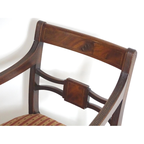 1558 - A Regency mahogany carver chair with a flame mahogany top rail and a shaped pierced mid rail, having... 