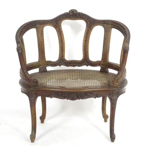 1559 - An early 20thC French Louis VI style chair with a carved and moulded frame above a caned seat, stand... 