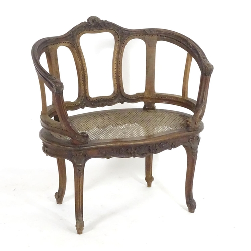 1559 - An early 20thC French Louis VI style chair with a carved and moulded frame above a caned seat, stand... 