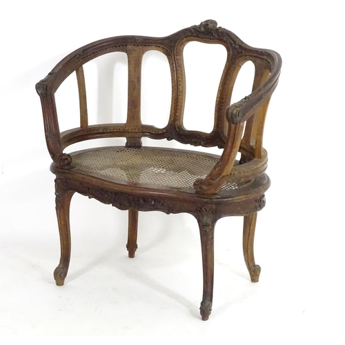 1559 - An early 20thC French Louis VI style chair with a carved and moulded frame above a caned seat, stand... 