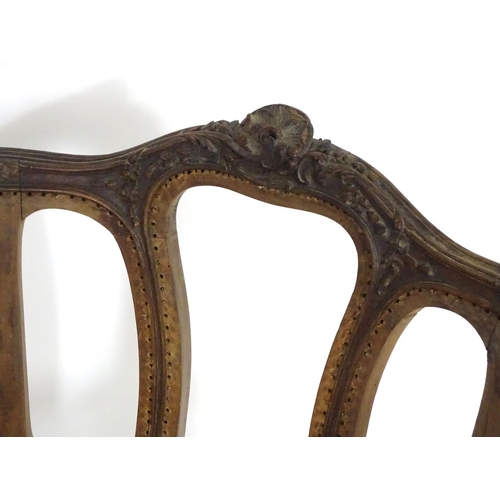 1559 - An early 20thC French Louis VI style chair with a carved and moulded frame above a caned seat, stand... 