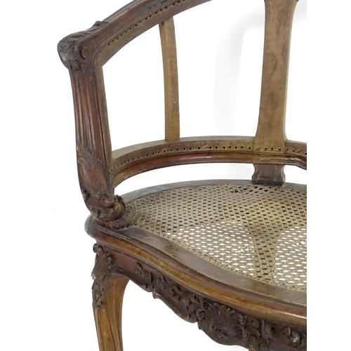 1559 - An early 20thC French Louis VI style chair with a carved and moulded frame above a caned seat, stand... 