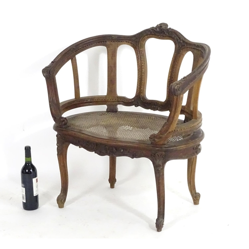 1559 - An early 20thC French Louis VI style chair with a carved and moulded frame above a caned seat, stand... 