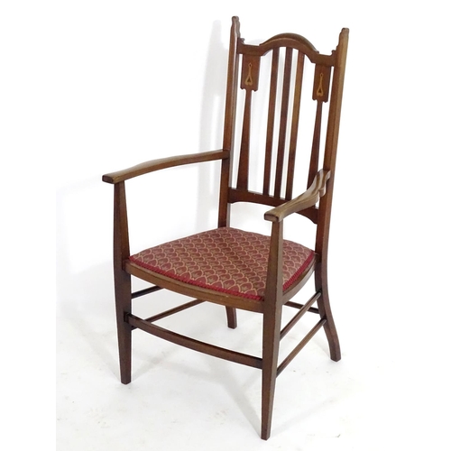 1560 - An early 20thC mahogany Arts & Crafts chair with a shaped, slatted backrest and marquetry inlay. 21