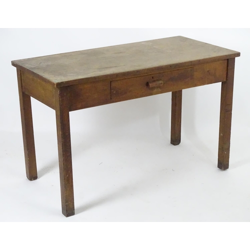 1563 - A mid 20thC fruitwood and oak desk with a rectangular top above a single short drawers and raised on... 